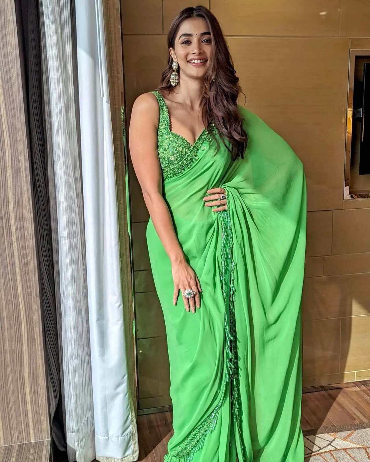 Pooja knows how to go green when it comes to clothes. She effortlessly stuns in a light green saree with delicately embroidered sleeveless blouse. The actress sure knows how to style monotone sarees